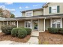 Inviting two-story house with a covered porch, complemented by verdant bushes, and a decorative wreath at 2745 Tiergarten Ln, Charlotte, NC 28210