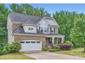 Charming two-story home with a brick facade, attached garage, and well-manicured front yard at 2864 Park Ridge Blvd, Rock Hill, SC 29732