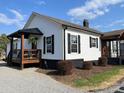 Well-kept house featuring a covered porch, dark trim, and meticulously graveled landscaping at 3186 Catawba St, Claremont, NC 28610