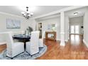 The dining room is decorated with hardwood floors, white walls, and an elegant chandelier at 332 Shiloh S Rd, York, SC 29745