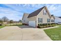 Angle view of home featuring a long driveway leading to an attached two-car garage at 332 Shiloh S Rd, York, SC 29745