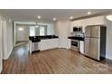Modern kitchen with stainless steel appliances, granite countertops, and white cabinetry at 3608 Shadowcrest Dr, Concord, NC 28027