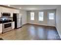 Bright kitchen with stainless steel appliances, a dining area, and access to the backyard at 3608 Shadowcrest Dr, Concord, NC 28027