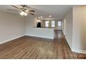 Open living space with wood-look floors, modern lighting, and seamless flow to the kitchen at 3608 Shadowcrest Dr, Concord, NC 28027