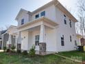 This is a charming two-story home featuring a welcoming front porch with stone accents and white pillars at 502 Geneva Cir, Gastonia, NC 28056