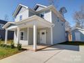 Charming two-story home featuring a covered front porch and long driveway at 554 Geneva Cir, Gastonia, NC 28056