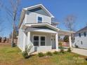 Charming two-story home featuring a covered front porch and well-manicured front lawn at 554 Geneva Cir, Gastonia, NC 28056