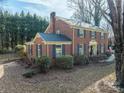 Charming brick home with dark shutters, lush landscaping, and mature trees on an expansive lot at 610 2Nd Nw Ave, Conover, NC 28613