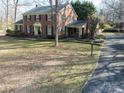 Attractive brick home with an inviting front entrance, mature trees, and a well-manicured lawn at 610 2Nd Nw Ave, Conover, NC 28613