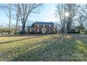 Two-story brick home featuring classic architecture, a green lawn and mature trees at 610 2Nd Nw Ave, Conover, NC 28613