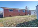 Brick home's backyard with a clothesline at 720 Pleasant Ave, Kannapolis, NC 28081