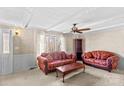 Living room featuring two red sofas, coffee table, and ceiling fan at 906 Harmony Dr, Statesville, NC 28677