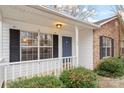 Cozy front porch featuring a blue front door with white trim and a well-kept lawn with green bushes at 1109 Cherry Meadow Ln, Rock Hill, SC 29732