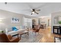 Bright living room featuring hardwood floors, neutral walls, a modern ceiling fan and furniture arrangement at 1109 Cherry Meadow Ln, Rock Hill, SC 29732