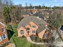 A stunning aerial view of a brick house showcasing its manicured lawn and surrounding neighborhood at 11402 Bloomfield Dr, Charlotte, NC 28277