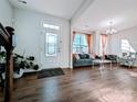Inviting living room with hardwood floors, decorative lighting, and a bright, airy feel at 12712 Wandering Brook Dr, Charlotte, NC 28273