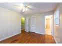 Bright bedroom boasts wood floors, neutral walls, and a ceiling fan at 128 Summerlea Dr, Charlotte, NC 28214