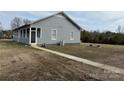 Exterior view of home featuring a covered porch and large backyard at 135 Waycross Dr, Rockwell, NC 28138