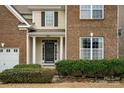 Welcoming front porch with white columns and a cozy entrance surrounded by well-maintained landscaping at 14104 Green Birch Dr, Pineville, NC 28134