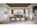 Bright dining room with a spacious table set for six beneath an elegant decorative wood paneled ceiling at 1437 Samuel Spencer Pkwy, Davidson, NC 28036