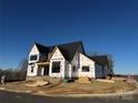 New construction home with black windows and roof under blue skies, awaiting finishing touches at 1437 Samuel Spencer Pkwy, Davidson, NC 28036