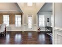 Elegant foyer featuring dark hardwood floors, a decorative door and wainscoting details at 15416 Cimarron Hills Ln, Charlotte, NC 28278