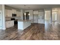 Open kitchen with island, hardwood floors, and stainless steel appliances at 156 Swann Rd # 7, Statesville, NC 28265