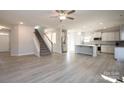 Open living room and kitchen with grey vinyl flooring and stainless steel appliances at 166 Swann Rd # 5, Statesville, NC 28625