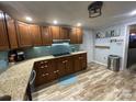 Well-lit kitchen featuring wood cabinets, granite countertops, and stainless steel appliances at 2227 Kenwood Dr, Kannapolis, NC 28081