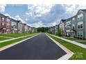 Street view of a community lined with well-manicured lawns, sidewalks, and craftsman-style townhomes at 434 Serenity Cir # F, Cramerton, NC 28032
