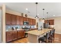 Well-equipped kitchen with stainless steel appliances, granite countertops, and a breakfast bar at 473 Bowline Dr, Denver, NC 28037