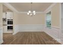 The dining room has hardwood floors, large windows, with a view into the kitchen area at 4849 Tacoma Dr, Fort Mill, SC 29707
