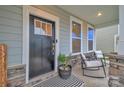 Cozy front porch offers a seating area, a decorative striped rug and a potted plant at 4849 Tacoma Dr, Fort Mill, SC 29707