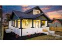 Charming renovated bungalow with a white brick facade and a welcoming front porch at 49 8Th Se St, Hickory, NC 28602