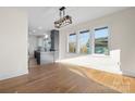 Open-concept living space with a view of the modern kitchen and natural light at 49 8Th Se St, Hickory, NC 28602