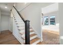 Classic staircase design with wooden steps, white risers, and black handrail at 49 8Th Se St, Hickory, NC 28602