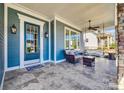 Cozy front porch with comfortable seating, a ceiling fan, and elegant tile flooring at 520 Crawfish Dr, Fort Mill, SC 29708