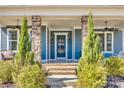 Inviting front porch showcasing stone columns, a stylish front door, and manicured greenery at 520 Crawfish Dr, Fort Mill, SC 29708