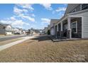 Street view featuring a well-maintained home with stone accents, sidewalk access, landscaping, and community setting at 7019 Lenton Rd, Charlotte, NC 28215