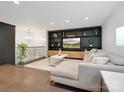 Stylish living room showcasing custom built-ins, a modern sectional sofa, and an open layout with natural light at 7314 Entwhistle Ct, Charlotte, NC 28226