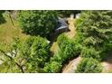 Aerial view of a secluded home surrounded by mature trees and greenery at 833 E Chestnut St, Stanley, NC 28164