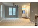 Bright living room featuring neutral carpet, a ceiling fan, and a view of the entry way at 11724 Blessington Rd, Huntersville, NC 28978