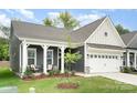 The exterior of this home boasts a covered porch, a well-maintained lawn, and a convenient two-car garage at 119 Winterberry St, Mooresville, NC 28117