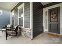 Inviting front porch with comfortable seating and tasteful landscaping, creating a warm welcome at 119 Winterberry St, Mooresville, NC 28117