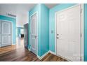 Bright entryway with blue walls, brown floors, and a view into the living area at 1475 Cypress Loop # 29, Newton, NC 28658