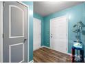 Light-filled entryway with modern lighting, wood-look floors and blue walls at 1475 Cypress Loop # 29, Newton, NC 28658