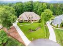 Expansive home surrounded by lush landscaping, a circular driveway and ample parking at 148 Castle Dr, Mooresville, NC 28117