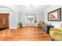 Living room with wood flooring, large bay windows, neutral paint, and elegant furnishings at 148 Castle Dr, Mooresville, NC 28117