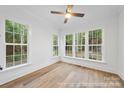Sun-drenched bedroom with large windows offering a scenic view of the outdoors and hardwood floors at 19155 Newburg Hill Rd, Davidson, NC 28036