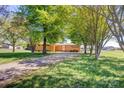 Well-maintained brick ranch with a large front yard and mature trees, offering curb appeal and a sense of privacy at 2004 Grandhaven Dr, Concord, NC 28027